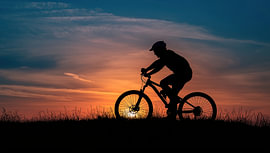 A person on a mountain bike by Bo Valentino