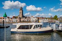 Ferry in river IJssel with skyline of Deventer, The Netherlands