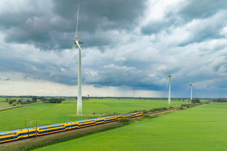 Train of the Dutch Railways driving past wind turbines by Sjoerd van ...