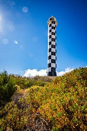 Coastal Lighthouse under a Blue Sky with Lens Flares by Patrick Kilb