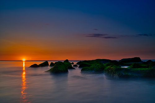 Rotsen uitwatering zonsondergang Katwijk aan Zee