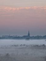 Village rises above the mist in The Netherlands.
