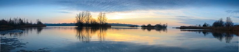 Sunset over a lake with small islands at the end of a winter day by Sjoerd van der Wal Photography