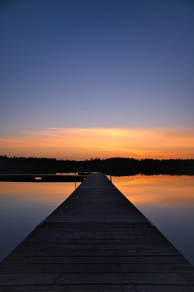 Jetty that reaches into a Swedish lake by Martin Köbsch