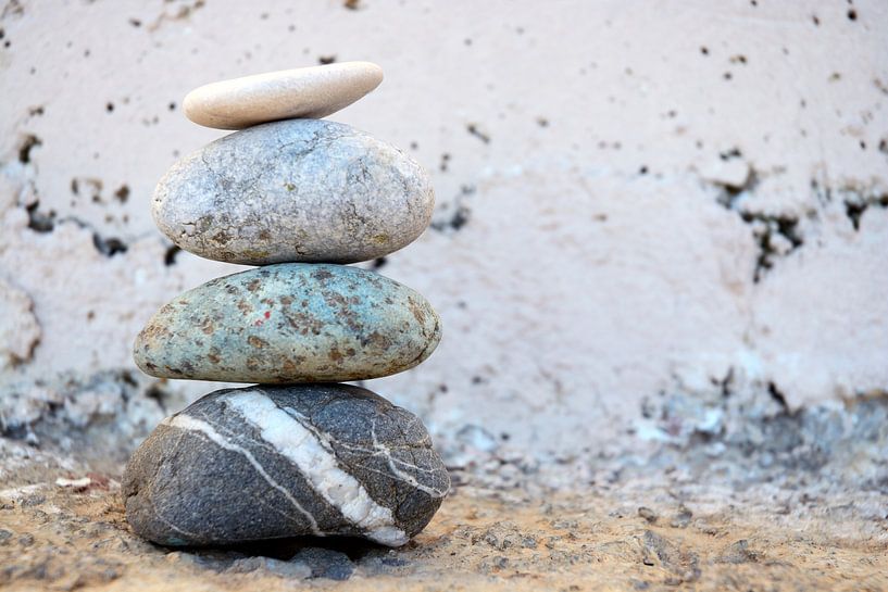 Zen pile of stones and boulders with an old background by Trinet Uzun