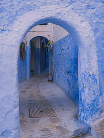 Blue street with typical Moroccan arches
