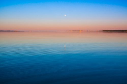 Turquoise sky dawn and turquoise water, the sun rises, Pleshcheyevo lake. smooth blue and turquoise 