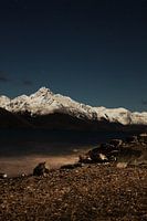 A starry sky with beautiful mountains covered with snow