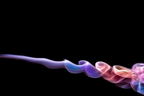 colorful smoke radiating tranquility on a black backround