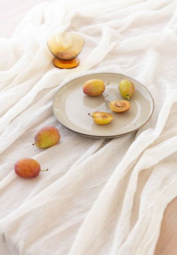 stilllife with prunes in soft daylight setting with warm colours by Caroline Martinot