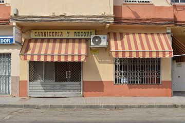 Striped awnings of an Andalusian butcher's shop in Chiclana by Silva Wischeropp