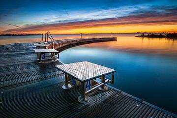 Outdoor swimming pool with jetty at sunrise by Fotografiecor .nl