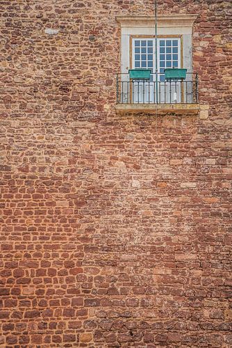 Old wall with doors and small balcony