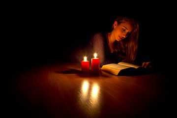 Reading with candle light by Anton de Zeeuw