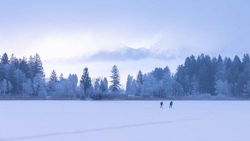 The Schwanensee in Schwangau in Bavaria Germany in Winter 2025 - Snow and Ice - unknown Scaters not recognizable - Winter Hiking
