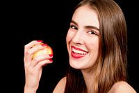 Young woman eats an apple