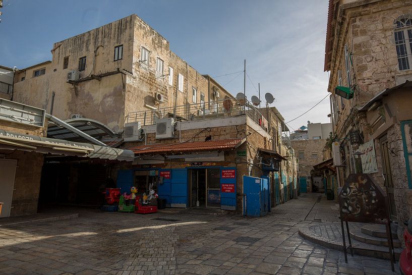 Street with shops in old town of Accra in Israel by Joost Adriaanse