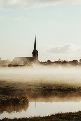 The church in Hoogmade, half-hidden in the mist above the quiet polder landscape