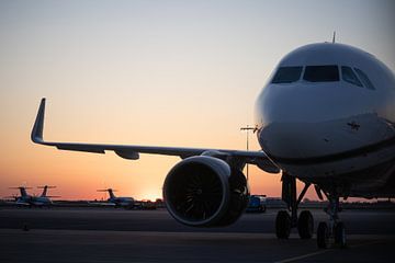 Private jet Airbus A319 during sunset by Maxwell Pels