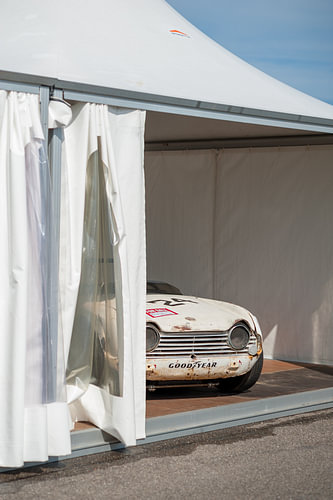 Rally car under a white tarpaulin