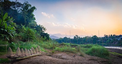 Bootje met viskorven aan de oever van de Nam Khan, Laos