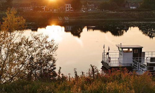 Ferry on the Maas at sunset in Eijsden, South Limburg, Netherlands