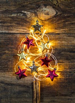 Christmas tree shape with golden and red stars and festive light decoration by Alex Winter