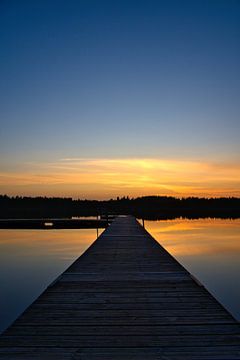 Jetty that reaches into a Swedish lake by Martin Köbsch