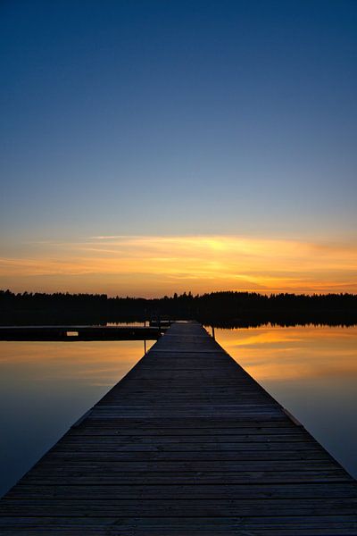 Jetty that reaches into a Swedish lake by Martin Köbsch