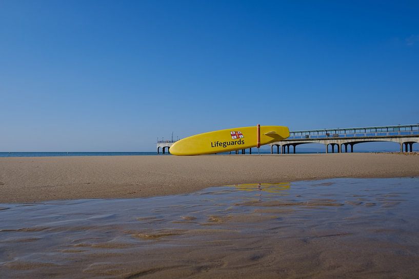 Beach with a lifeguard board by Robert Szczotka