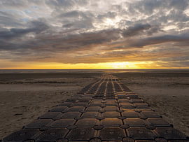 Long rubber jetty at sunset in Harlingen by R Smallenbroek