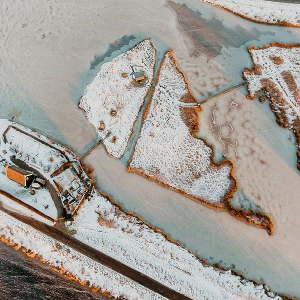Dutch polder island covered in snow surrounded by ice by Mike Helsloot