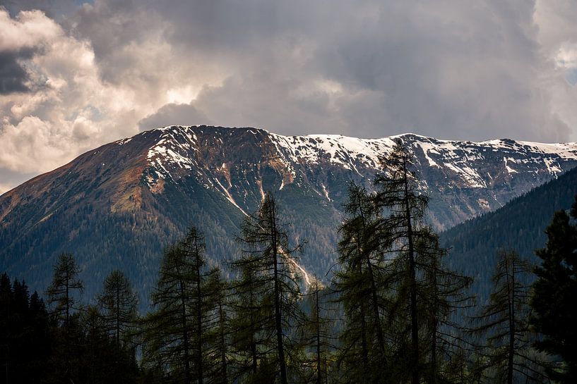 Swiss mountains with melting snow and sun by Dafne Vos