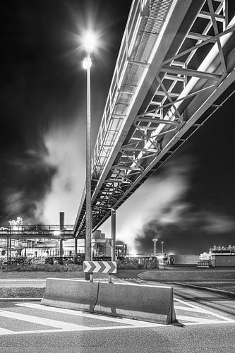 Pipeline bridge crossing road near refinery at night, Antwerp