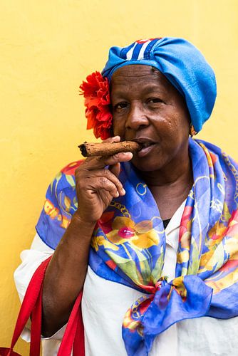 old woman with traditional clothes and cigar in old town of Havana Cuba