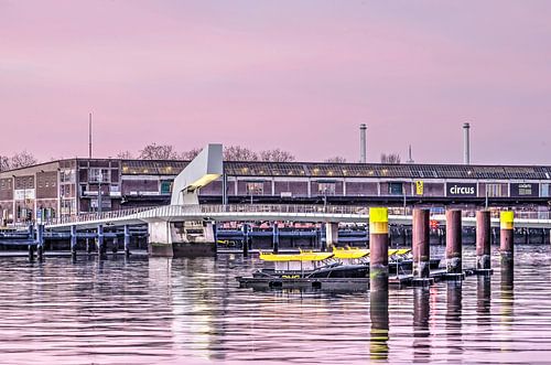 Watertaxi's, bridge and warehouse at sunrise