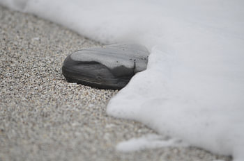 black stone in the surf
