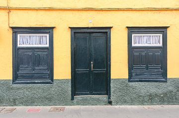 Yellow house facade with doors in Tenerife by Alexander Baumann
