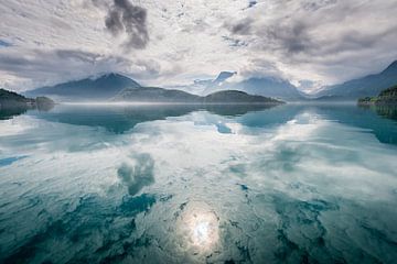 Reflection of mountains and clouds. Reflection of mountains and clouds in a lake. by Ellis Peeters