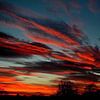 Vuurrode wolken bij zonsondergang van Joyce Derksen