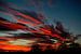 Vuurrode wolken bij zonsondergang van Joyce Derksen