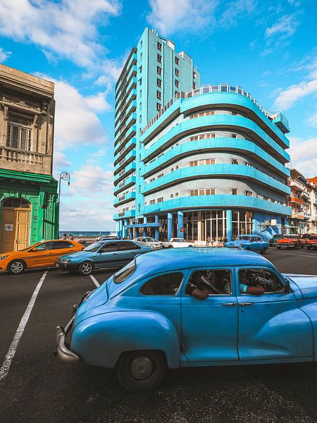 Cubaanse straathoek in Havana, het blauwe BelleVue Deauville hotel en een oldtimer van Michiel Dros