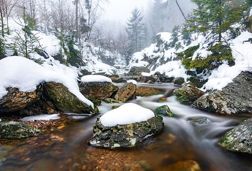 Rocks, snow and flowing water