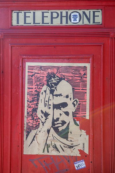 red phone booth with placard in london by Eric van Nieuwland