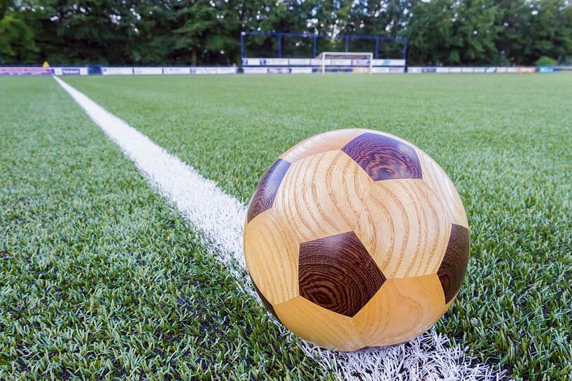 Wooden soccerball on sideline by Ben Schonewille