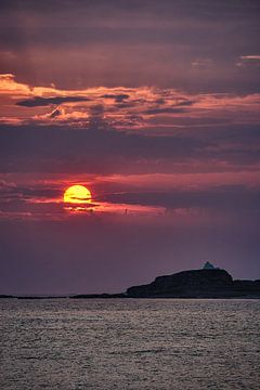 Sunset over the distant lighthouse of Erkna, Godøy, Norway by qtx