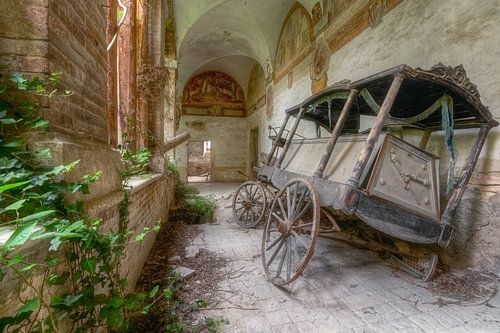 Corbillard abandonné dans un monastère vide.