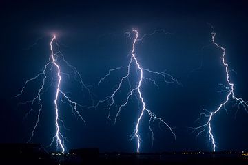 Three lightning strikes in a row by Menno van der Haven