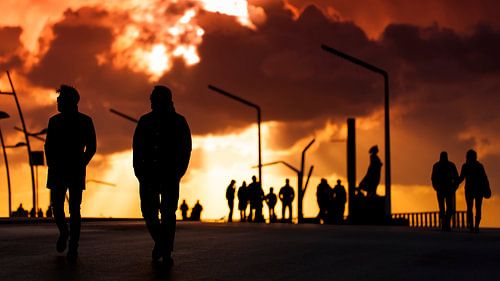 Silouettes of walkers on Scheveningen promenade by Rob Kints