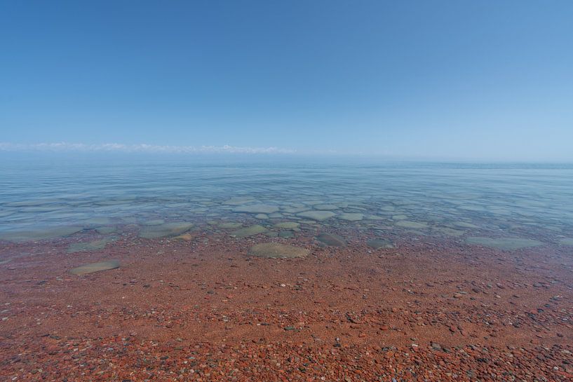 Issyk Kul lake with stones in the water by Mickéle Godderis